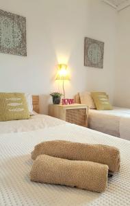 a bedroom with two beds and a table with a lamp at Cantinho de Milfontes 1 Twin in Vila Nova de Milfontes