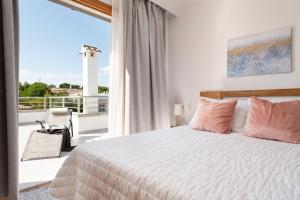 a bedroom with a bed and a large window at Villa Isabel in Playa de Muro