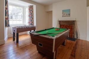um quarto com uma mesa de bilhar e uma lareira em Mulberry House em Holbeton