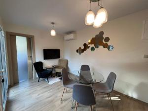 a living room with a glass table and chairs at Eden House in Druskininkai