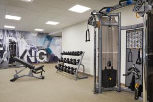 a gym with a bunch of equipment in a room at SpringHill Suites St. Louis Airport/Earth City in Bridgeton