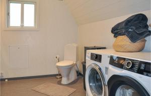 a washing machine in a bathroom with a toilet at 3 Bedroom Pet Friendly Apartment In Deje in Deje