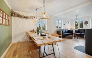 a dining room and living room with a table and chairs at Lovely Home In Aabenraa With Kitchen in Aabenraa