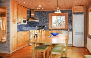 a kitchen with a wooden table and a refrigerator at 6 Bedroom Gorgeous Apartment In Slen in Sälen