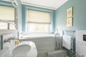 a bathroom with a sink and a window at Tacket Wood House in Kingsbridge