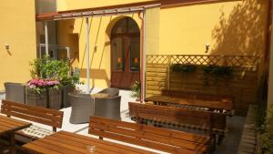 a group of benches sitting outside of a building at Hotel Ambiance in Prague