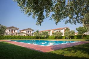 einen Pool in einem Hof mit Häusern in der Unterkunft Appartamento al Sole in Colà di Lazise
