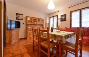 a kitchen and dining room with a table and chairs at Beautiful Apartment In Lusiana Conco With House A Mountain View in Conco