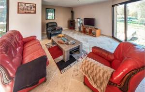 a living room with red leather furniture and a table at 3 Bedroom Gorgeous Home In Chilhac in Chilhac