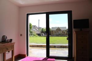 an open door with a view of a yard at Brackness House Luxury B&B in Anstruther
