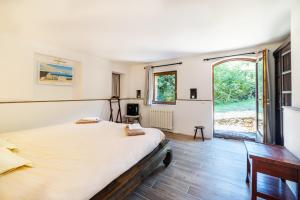 a bedroom with a large bed and a large window at Villa Casablanca in Montferrer +28 photos