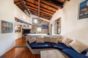 a living room with a blue couch and a stone wall at Villa Casablanca in Montferrer