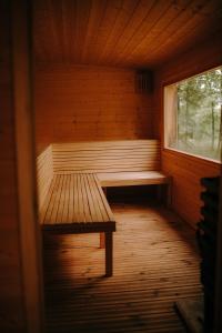 an empty sauna with a bench and a window at BioRezydencja in Świeradów-Zdrój