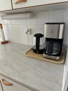 a coffee maker sitting on a counter in a kitchen at Welcomly apartment MILA in Kotka