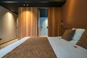 Letto o letti in una camera di Aux Etangs - Hôtel