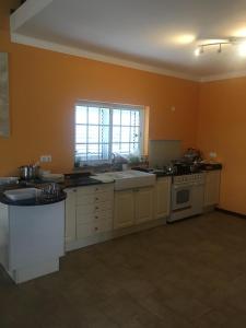 a kitchen with a sink and a stove top oven at Quinta Da Amoreira in Ferreira do Alentejo