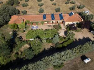 an aerial view of a house with solar panels on it at Hotel Rural La Cimbarra in Aldeaquemada