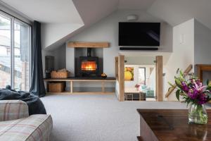 a living room with a fireplace and a couch at The Printworks in Salcombe