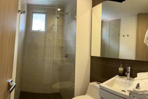 a bathroom with a shower and a toilet and a sink at Nice apartment independent in front business center in Bogotá