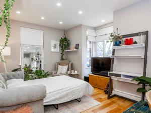 a living room with a bed and a tv at Amazing Lovely 1BDR Apartment, South London in Forest Hill