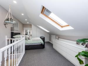 a bedroom with a bed and a skylight at Amazing Lovely 1BDR Apartment, South London in Forest Hill