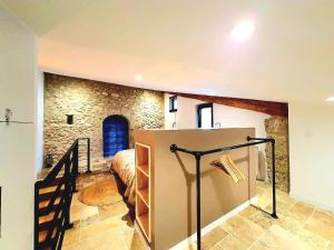 a bedroom with a bed and a staircase in a room at Gîtes VITAL Montagne in Peyrus