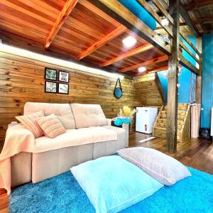 un soggiorno con divano e tappeto blu di cabanas Aconchego dos Canyons a Praia Grande