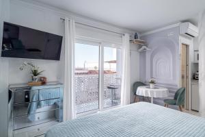 a bedroom with a bed and a view of a balcony at Silver horizon Luxury apartment in Nerja