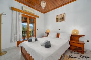 a bedroom with a large bed and a window at Alonia Cottage in Episkopí
