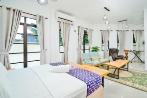 a bedroom with a bed and a table and a chair at Villapadu Desa in Kuala Terengganu