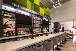 a bar with chairs and a large monitor above it at Portland Sheraton at Sable Oaks in South Portland