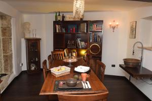 a dining room with a table and a book shelf at San Francesco Suite in Poggio Bustone +24 photos