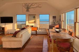 a living room with a couch and a table at Valleys & Views in Nantucket