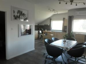 a dining room with a table and chairs at Appartement Andrea in Galambok +11 photos