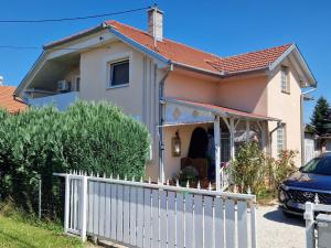 a house with a white fence in front of it at Appartement Andrea in Galambok