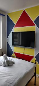 - une chambre avec un mur coloré et un lit dans l'établissement Richmond London 2 bed room Appartement, à Londres