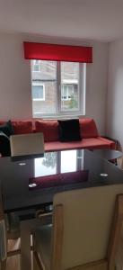 a room with a couch and a table and a window at Richmond London 2 bed room Appartement in London