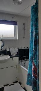 a bathroom with a tub and a sink and a bath tub at Richmond London 2 bed room Appartement in London