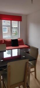 a room with two beds and a table and a window at Richmond London 2 bed room Appartement in London