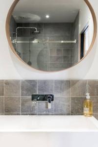 a bathroom with a mirror and a sink at Cabana & Appartement type Loft - Bellecour in Lyon