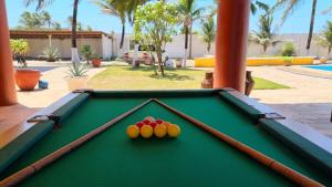 a pool table with three balls on top of it at mansao922 in Aquiraz
