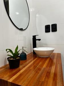 a bathroom with a white sink and a mirror at Casa de los lagos in Rivera