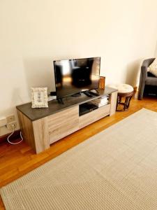 a flat screen tv sitting on a entertainment center in a living room at Maison Vidal II in Coubisou