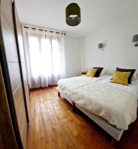 a bedroom with a large bed and a window at Maison Vidal II in Coubisou