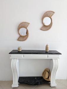 a white console table with two mirrors on the wall at Tropical Leaves Sea view penthouse in Sal Rei