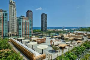 a view of a rooftop patio with tables and chairs at The St. Regis Chicago in Chicago