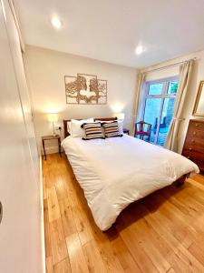 a bedroom with a large white bed and a window at Holland House in New Brighton