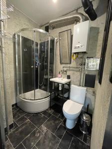 a bathroom with a shower and a toilet and a tub at Absolutely Apartment in Krakow