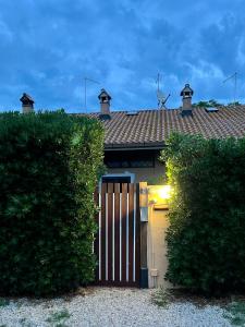 a garage with a gate in front of a house at Casa Vacanze La Riserva Maccarese in Maccarese