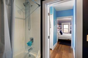 a bathroom with a shower and a bath tub at Cape Cod Mod in Provincetown